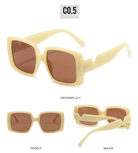 Detail view of square beige sunglasses with brown lenses and geometric wide temples