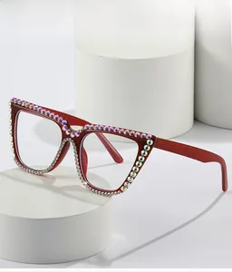 Close-up of deep red square sunglasses with colorful rhinestones on white display