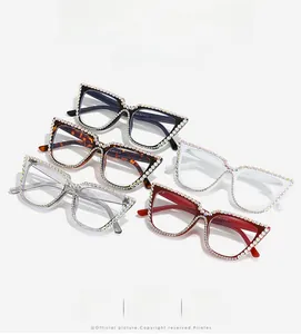 Detail of five rhinestone cat-eye glasses frames in black, tortoiseshell, white and red