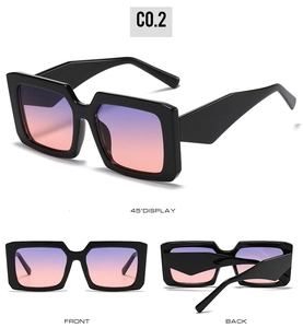 Detail view of square sunglasses with thick black frames and purple gradient lenses