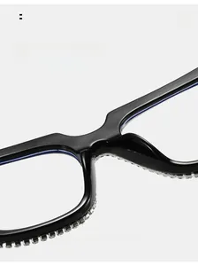 Close-up of black thick-frame sunglasses featuring sparkling rhinestones and nose pads