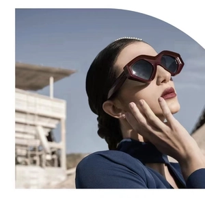 Fashionable dark red cat eye sunglasses with thick geometric frames and dark lenses