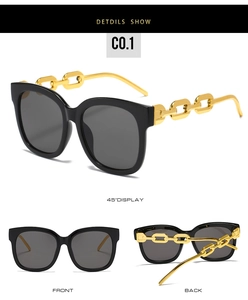 Detail view of square sunglasses featuring bold black frames and gold chain temples