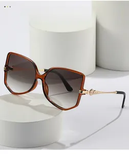 Detailed view of amber frames with gradient lenses and textured gold metal temples