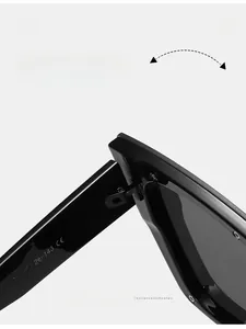 Detail of metal hinge structure and CE specs on black oversized cat-eye sunglasses