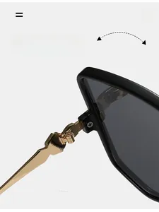 Close-up of durable golden metal hinges on thick black frames of stylish sunglasses