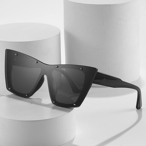Fashionable oversized cat eye sunglasses with silver rivets and dark grey lenses for women