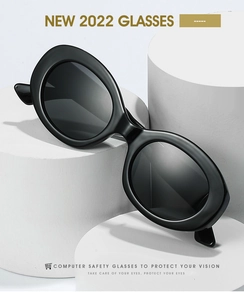 Detail view of oval black frame sunglasses on minimalist white geometric display pedestals
