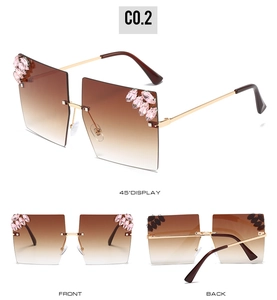 Detail view of oversized rimless square sunglasses with pink crystals and metal temples