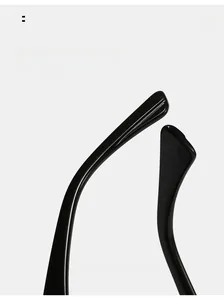 Detail of glossy black oval sunglasses featuring ergonomic curved mirror legs for comfort