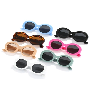 Set of seven vintage oval sunglasses in multiple colors with dark protective lenses