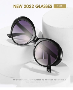 Detail of round black sunglasses with gradient purple lenses on minimalist white pedestals