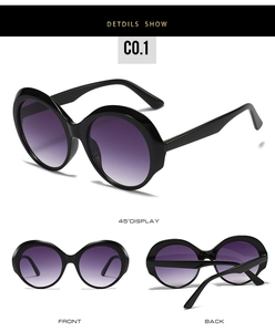 Detail view of retro round sunglasses with black frame and purple gradient lenses
