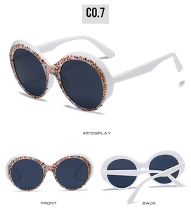 Detailed views of white round sunglasses with orange and black patterned frame textures