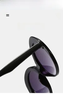 Detail of sturdy metal hinges and polished black frames on retro round sunglasses