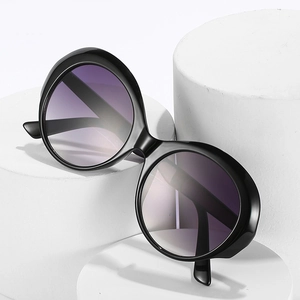 Retro oversized round sunglasses with black frames and purple gradient lenses on white display