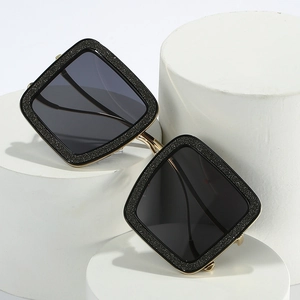 Oversized square sunglasses with sparkling black glitter frames and gold metal temples