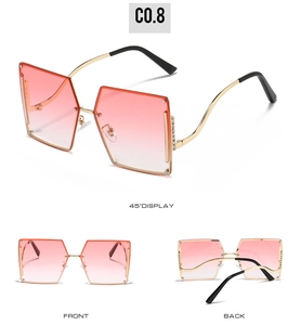 Detail view of rimless rhinestone sunglasses with pink gradient lenses and gold frame