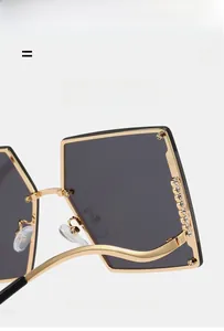Detail of rimless gradient sunglasses with gold metal frame and sparkling rhinestones
