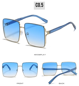 Detail view of square sunglasses with gold metal frame and gradient blue lenses