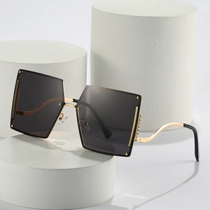 Frameless oversized gradient sunglasses with gold wavy temples and rhinestone accents