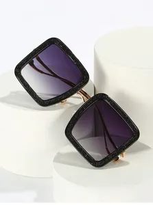 Detail of square glitter sunglasses featuring purple gradient lenses on white display pedestals