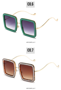 Detail view of square glitter sunglasses with wavy metal temples and gradient lenses