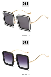 Detail view of square glitter sunglasses with unique golden wave-shaped metal temples