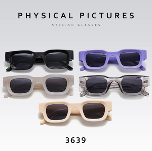 Detailed flat lay of rectangular punk sunglasses in black, purple, grey, and beige finishes