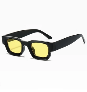 Close-up of retro square sunglasses featuring a thick black frame and yellow tinted lenses
