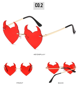 Detailed views of red heart devil sunglasses with gold metal temples and rimless lenses