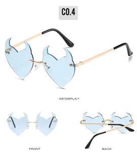 Detail of rimless heart-shaped flame sunglasses with blue lenses and gold metal temples