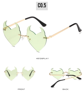 Three views of heart-shaped devil horn sunglasses with green lenses and gold frames