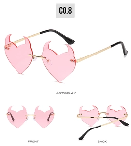Detailed views of pink heart-shaped devil horn sunglasses with gold metal frames