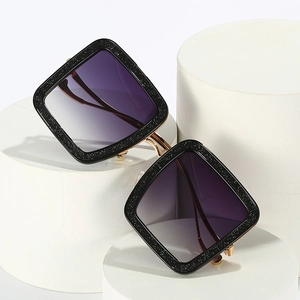 Square oversized sunglasses with black glitter frames and purple gradient lenses