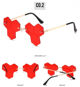 Detailed views of red rimless hexagonal honeycomb sunglasses with gold metal frames