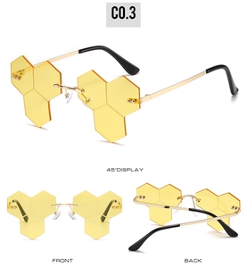 Three angles of rimless hip-hop sunglasses with amber honeycomb lenses and gold frame