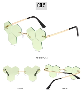 Three-angle display of rimless hip-hop sunglasses with green hexagonal honeycomb lenses