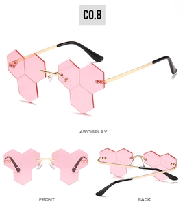 Three-view display of pink rimless hexagonal honeycomb sunglasses with gold metal temples