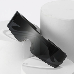 Futuristic rimless wrap-around sunglasses with gradient black lenses on a white display pedestal