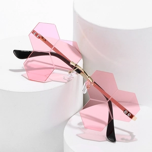 Chic rimless sunglasses with pink geometric petal lenses on white podiums