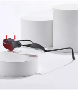 Red flame-shaped sunglasses on white pedestals featuring creative translucent lenses
