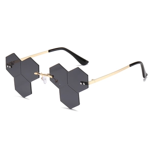 Fashionable rimless honeycomb sunglasses with grey hexagonal lenses and gold metal temples