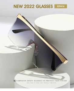 Close-up of oversized gradient purple lenses with elegant gold metallic trim detail