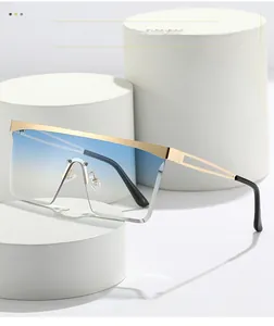 Close-up of gold metal frame sunglasses with blue gradient lenses and geometric hollow temples