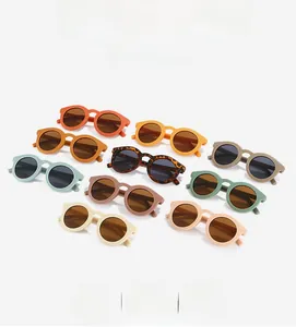 Flat lay of retro round sunglasses in ten colorful frame options for kids