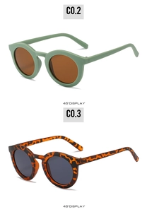 Detail view of round vintage sunglasses in olive green and tortoise shell frames at 45 degree