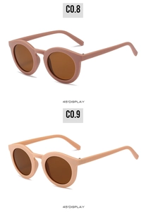 Detailed 45-degree view of retro round sunglasses in matte pink and almond beige frames