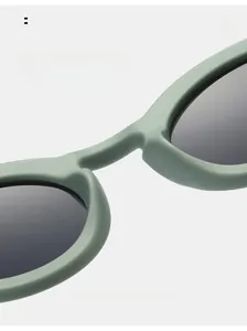 Macro detail of comfortable nose pads on matte grey-green round frame sunglasses