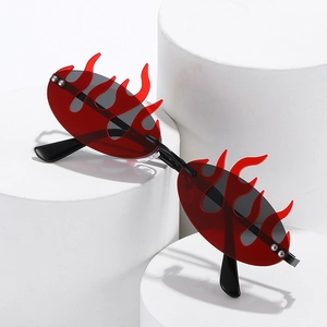 Hip hop flame-shaped sunglasses with red lenses on white display pedestals